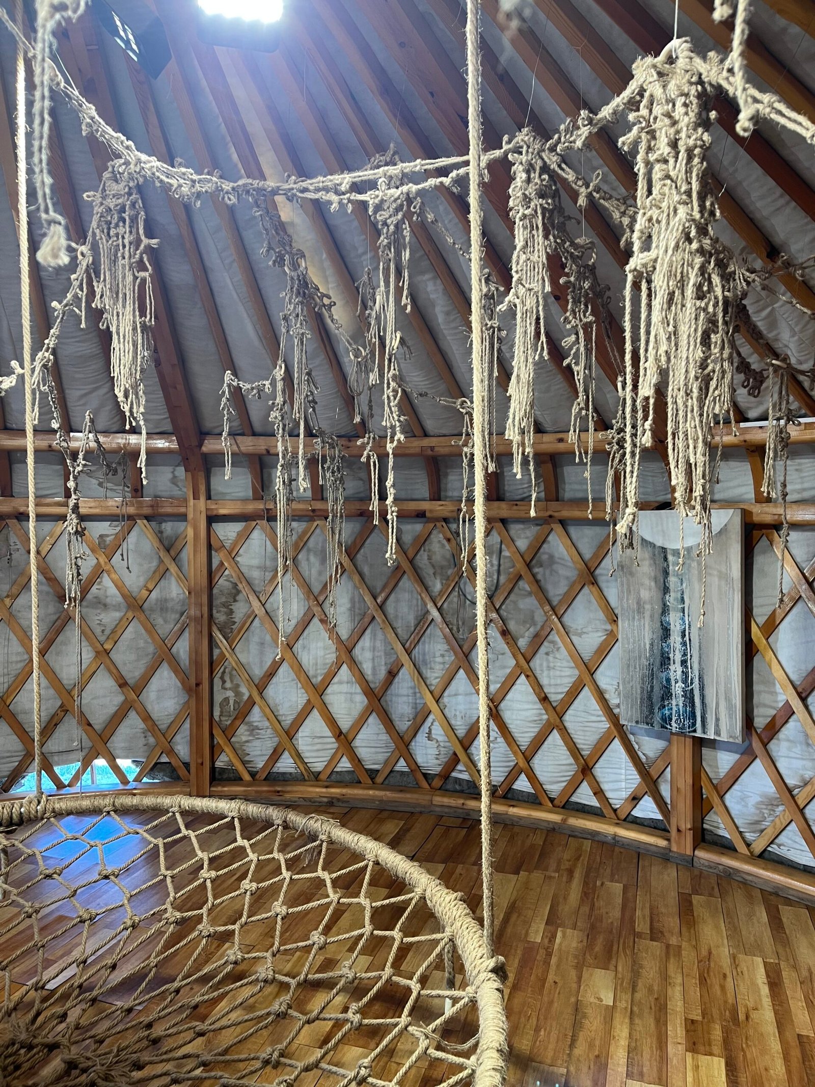 Interior view of a Mongolian ger showing the traditional wooden lattice frame and ceiling structure