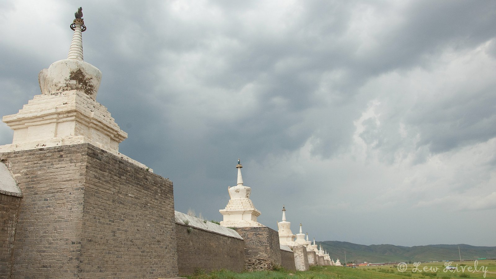 Erdene Zuu Monastery white stupas and perimeter wall under storm clouds, Kharkhorin Mongolia