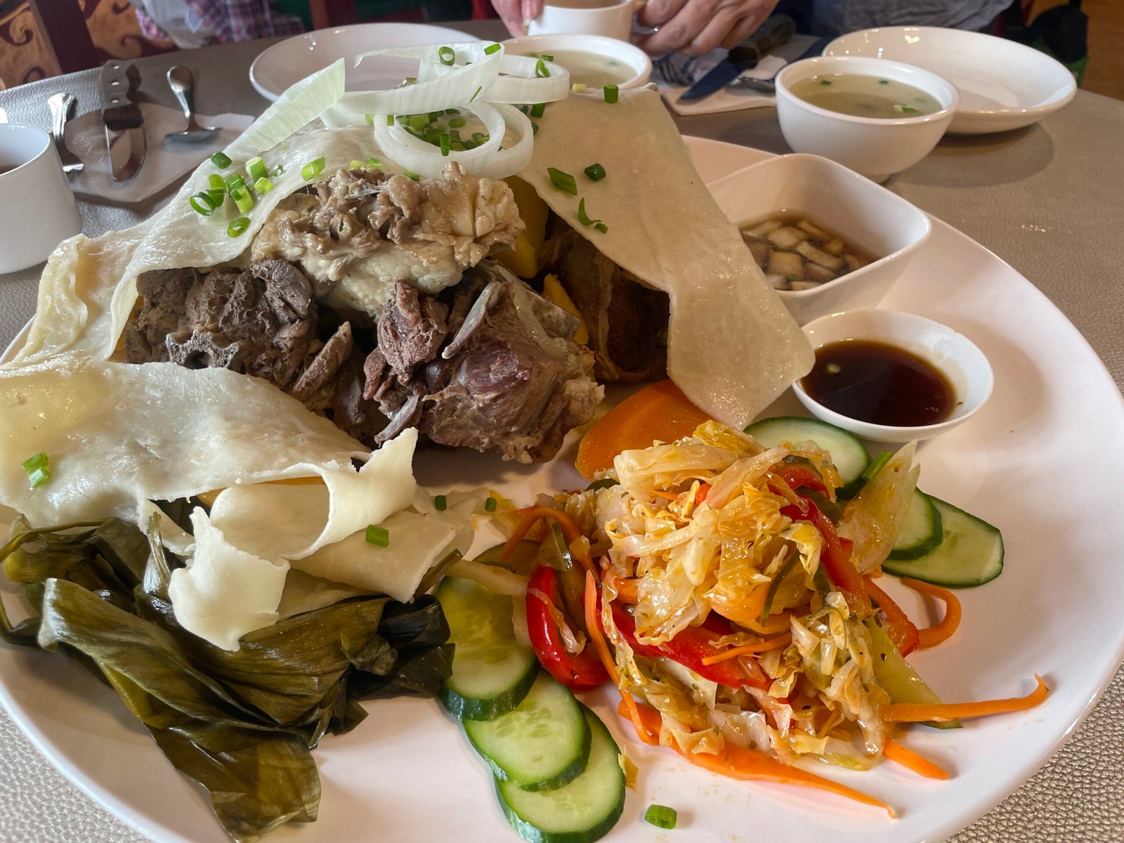 Mongolian khorkhog hot-stone barbecue served with flatbread and fresh salad