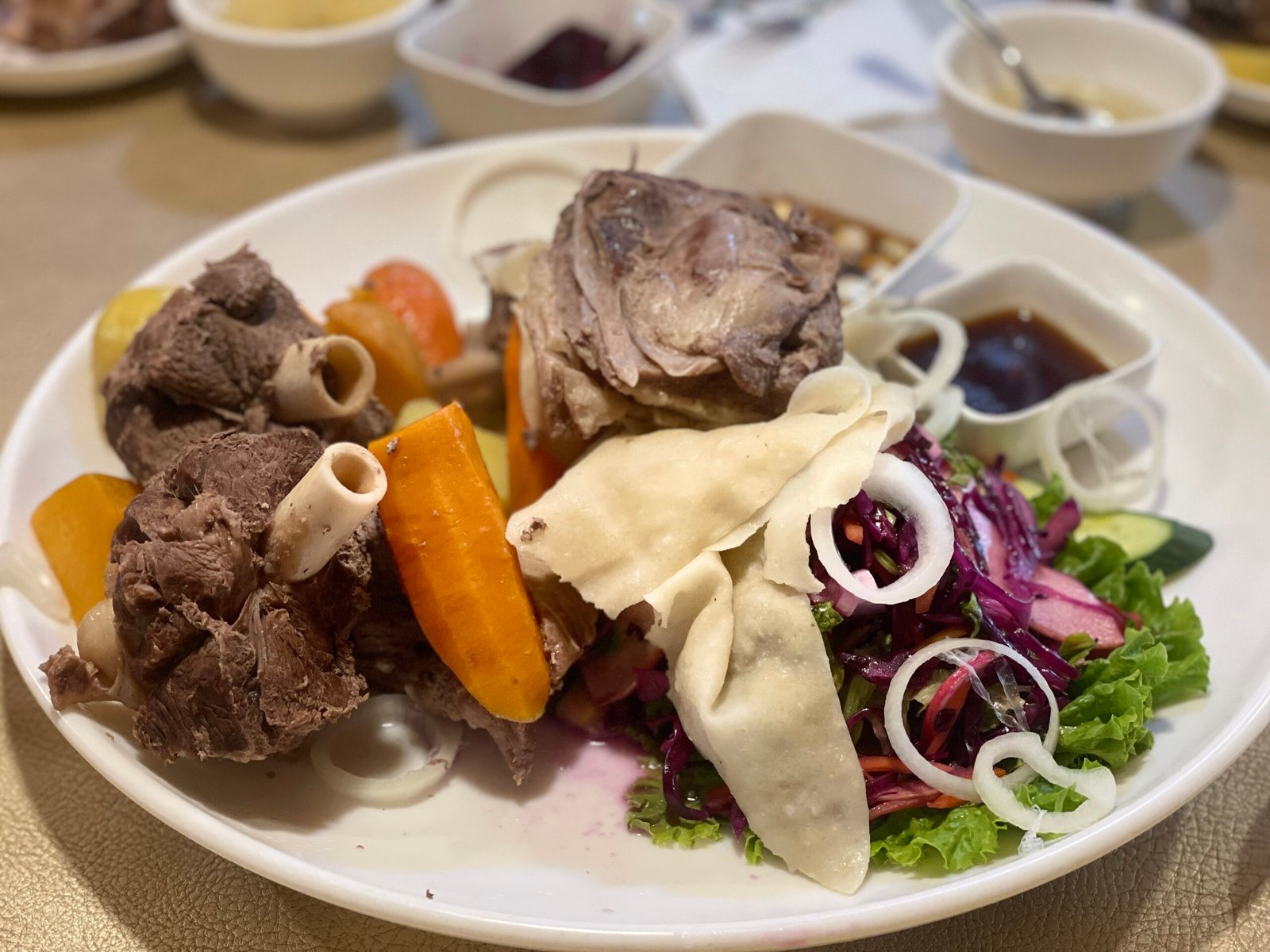 Mongolian tsuivan stir-fried noodles with meat and carrots served in a traditional bowl