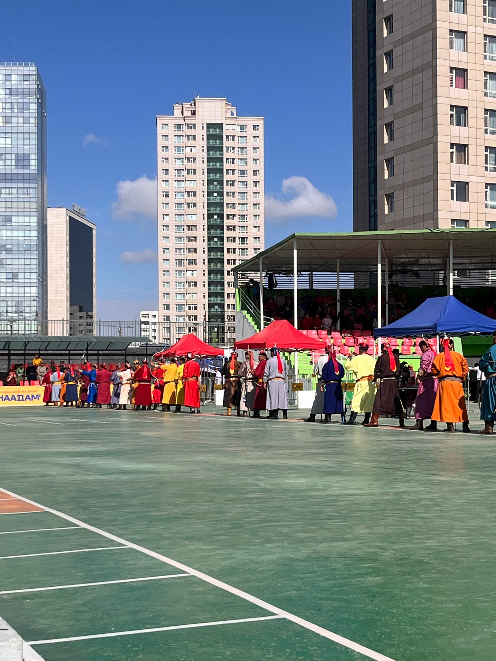 Mongolian archers in colorful traditional deel costumes competing at Naadam Festival archery competition in Ulaanbaatar