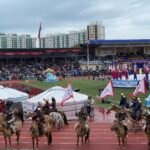 Naadam Festival opening ceremony horsemen galloping at National Stadium Ulaanbaatar Mongolia