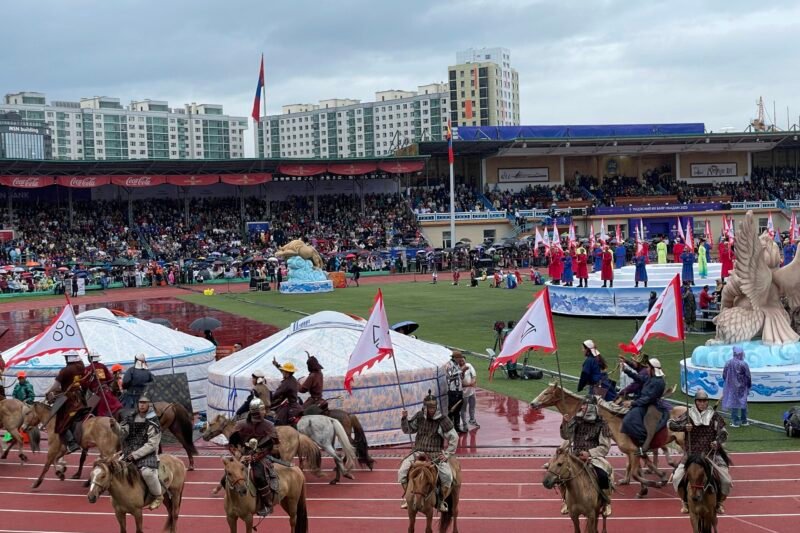 Naadam Festival opening ceremony horsemen galloping at National Stadium Ulaanbaatar Mongolia