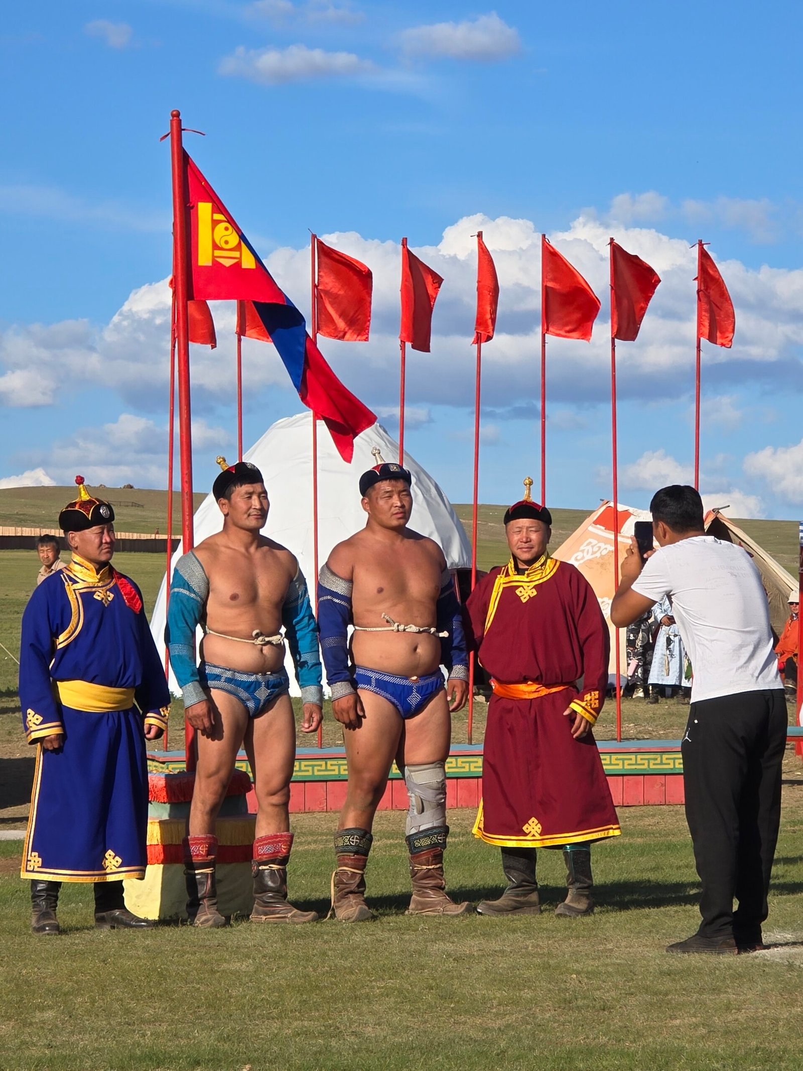 Naadam wrestlers competing in traditional bökh costume at Mongolia's national festival