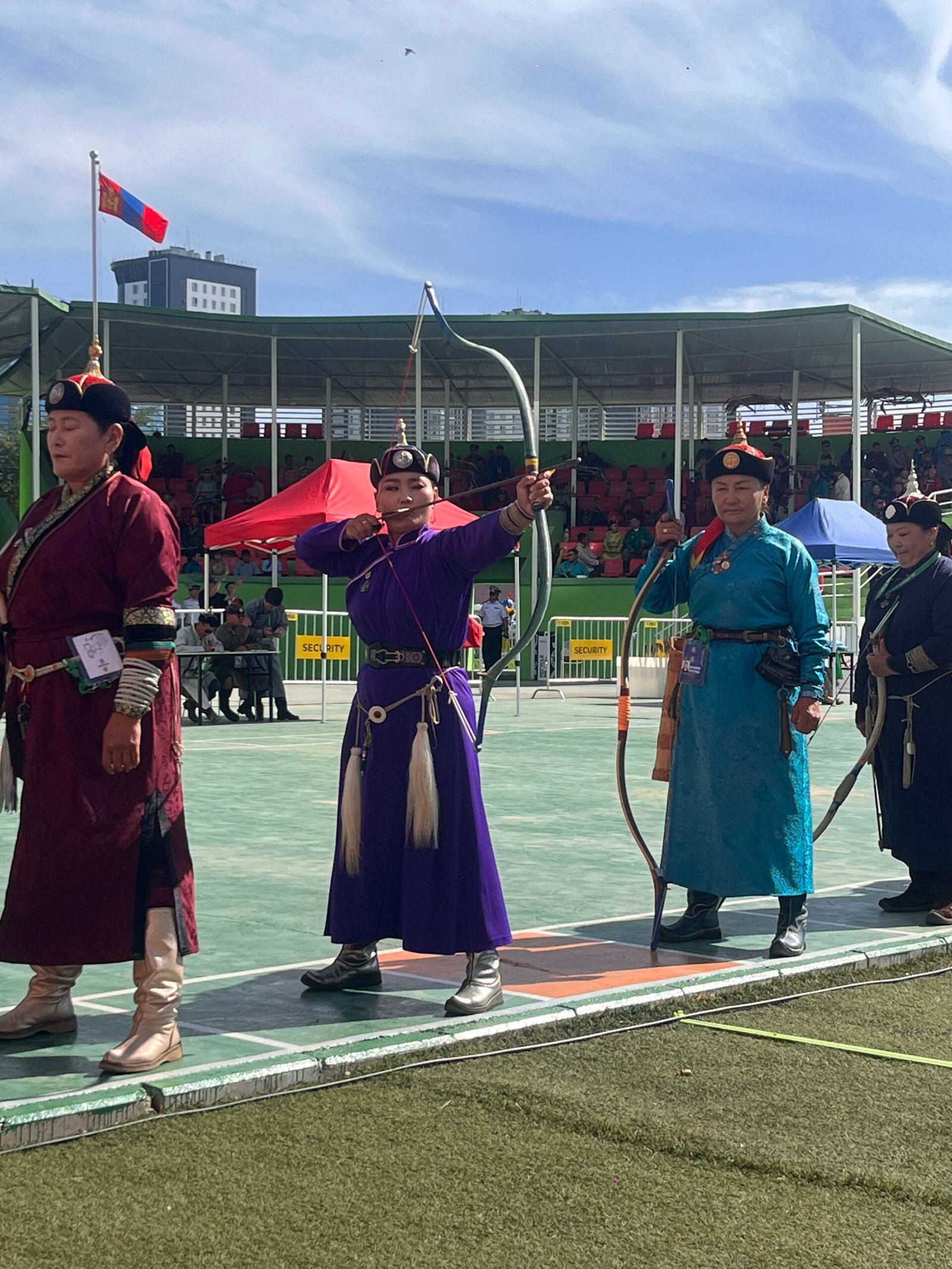 Naadam archery competition, traditional costumes, Ulaanbaatar stadium