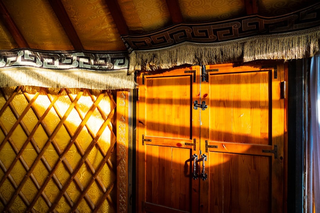 Interior of a traditional Mongolian ger showing the circular lattice structure and furnishings